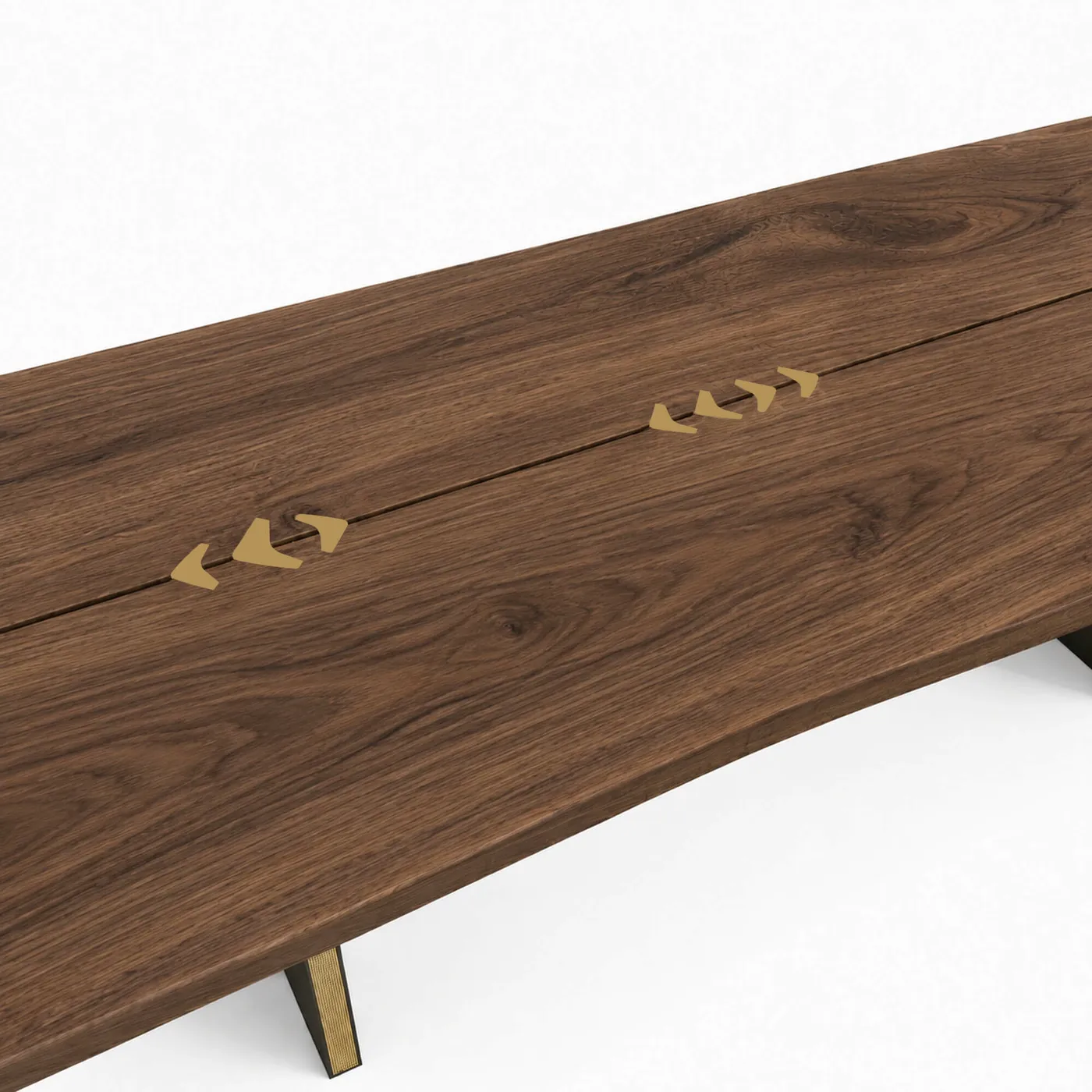 Brass butterfly joints set across the fissure of the walnut top, in Ex Forti’s pattern