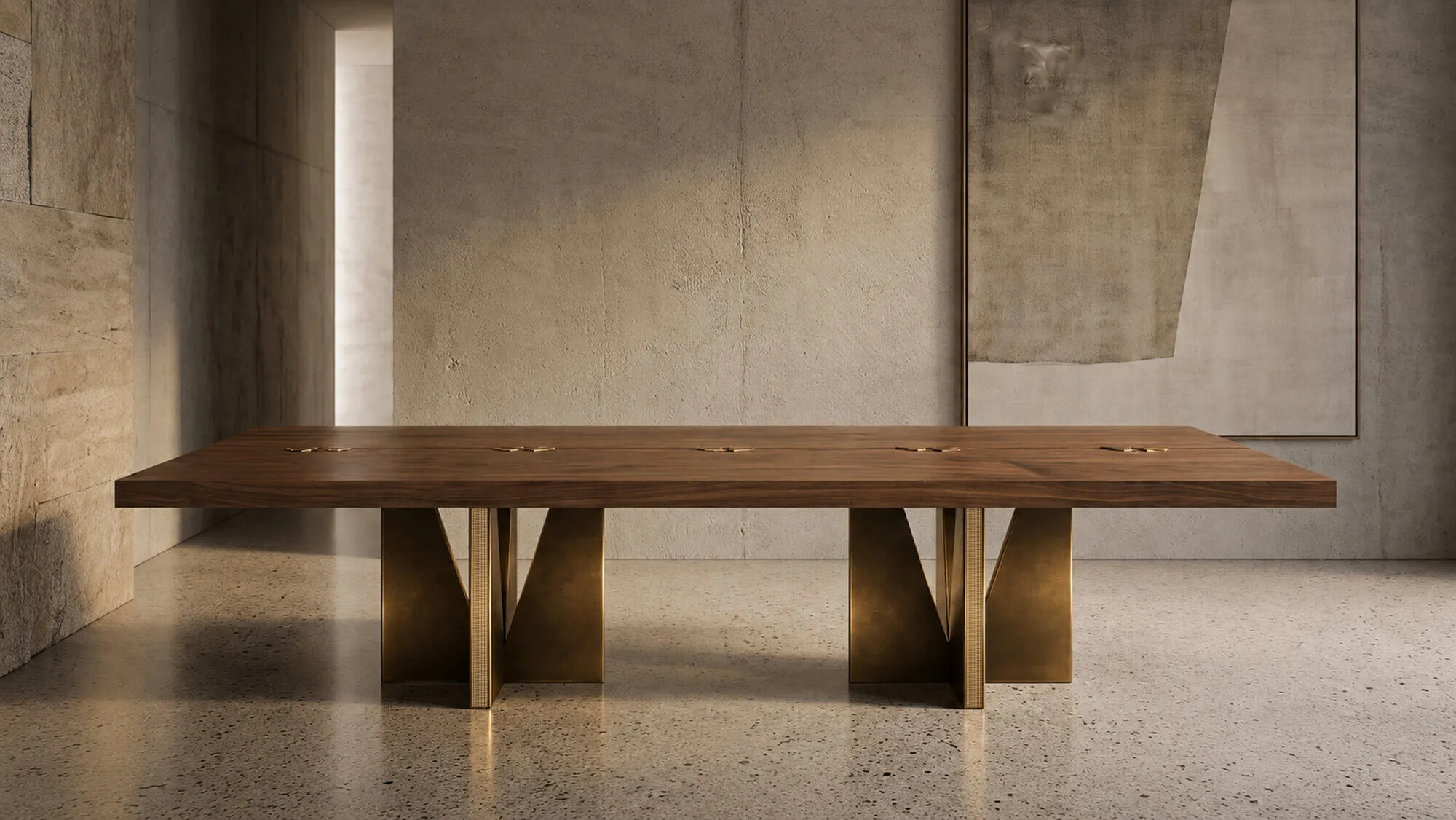 AURUM along its full length: a long solid walnut top inlaid with brass joints, on two bronze and brass bases